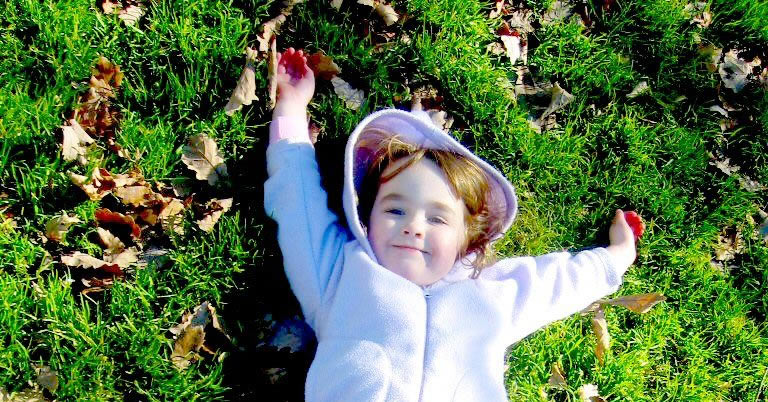 Little Girl Laying on Grass